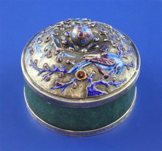 A 20th century Chinese silver and enamel mounted green hardstone circular box and cover, 2.5in.